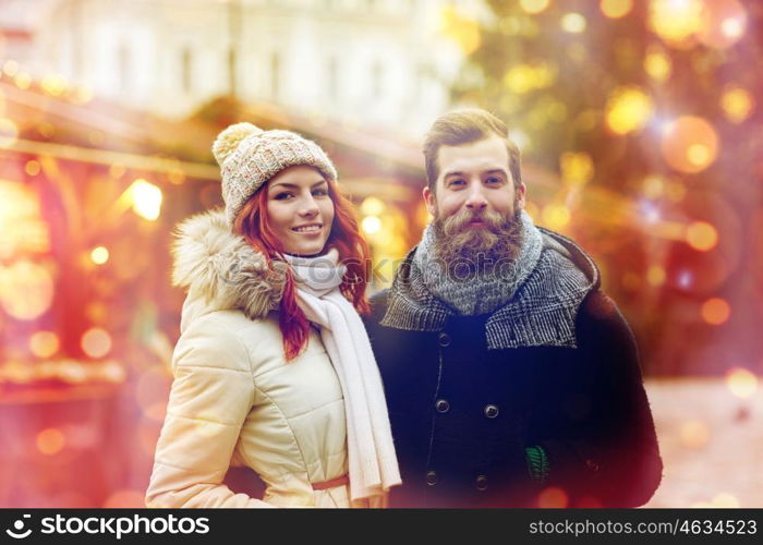 holidays, winter, christmas, tourism and people concept - happy couple in warm clothes walking in old town