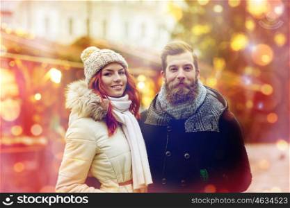 holidays, winter, christmas, tourism and people concept - happy couple in warm clothes walking in old town