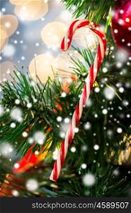 holidays, x-mas, decor and celebration concept - close up of close up of sugar cane candy decoration on christmas tree