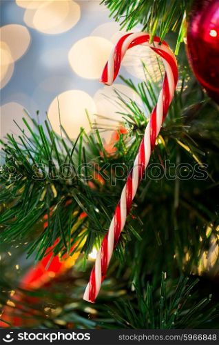 holidays, x-mas, decor and celebration concept - close up of close up of sugar cane candy decoration on christmas tree