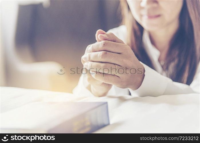 Holy bible prayer believe in god church. Woman hands pray christian bible for god blessing wishing better life. begging forgive and believe goodness. Christian life crisis prayer to god in church.