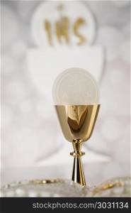 Holy communion a golden chalice with grapes and bread wafers. Eucharist, sacrament of communion background