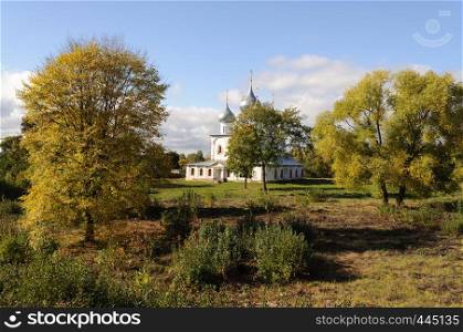 Holy Cross Cathedral (1658) among the trees in Tutaev town, Yaroslavl region, Russia. Sunny autumn day.