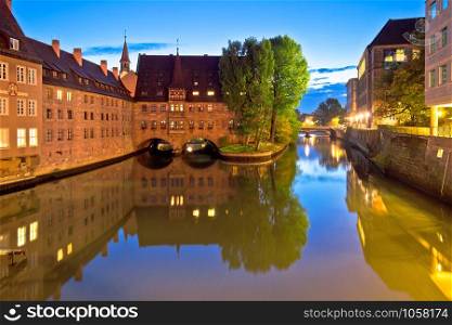 Holy Spirit Hospital evening view (Heilig-Geist-Spital) on river Pegnitz in Nuremberg, Bavaria region of Germany