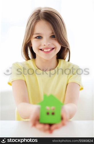 home and family concept - little girl holding green paper house