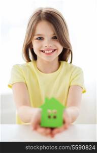 home and family concept - little girl holding green paper house