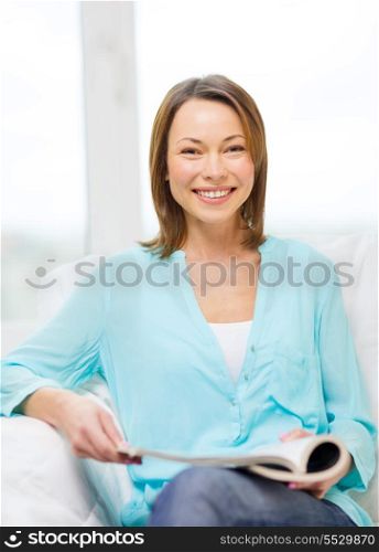 home and leasure concept - smiling woman reading magazine at home