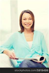 home and leasure concept - smiling woman reading magazine at home. smiling woman reading magazine at home