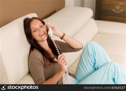 Home attractive smiling woman calling phone in living room