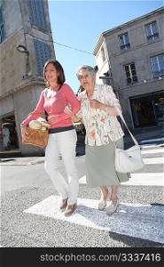 Home carer with elderly person in town