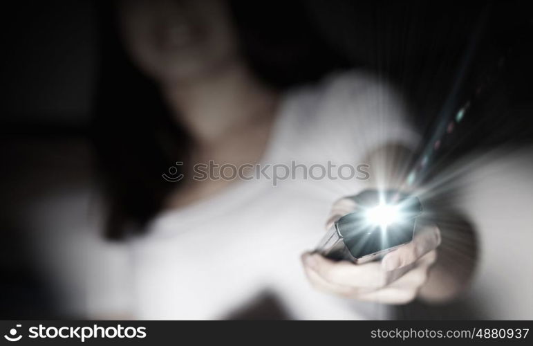 Home cinema. Close up of young woman with click in hand changing channels