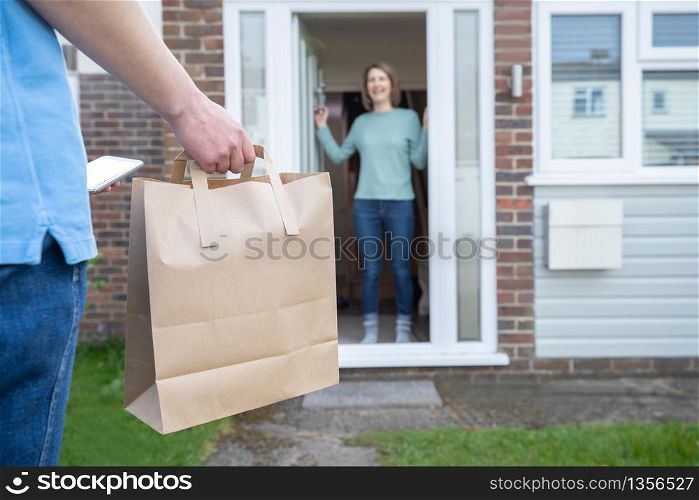 Home Delivery Of Takeaway Food Outside House Observing Safe Social Distancing During Coronavirus Covid-19 Pandemic