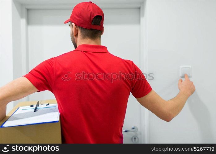 home delivery service, mail, people and shipment concept - man with parcel box ringing customers door bell. delivery man with parcel box ringing door bell