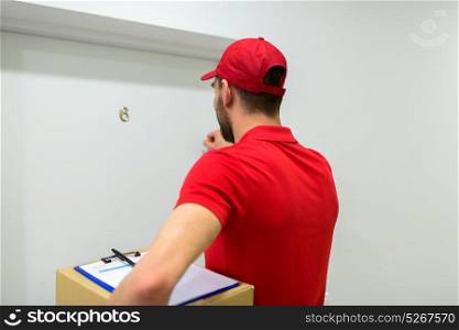 home delivery service, mail, people and shipment concept - man with parcel box knocking customers door. delivery man with parcel box knocking door