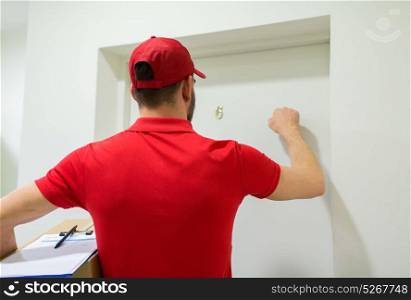 home delivery service, mail, people and shipment concept - man with parcel box knocking customers door. delivery man with parcel box knocking door