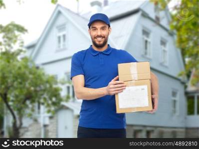 home delivery service, mail, people, logistics and shipping concept - happy man with parcel boxes over house background