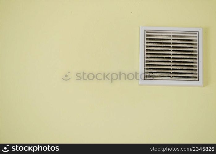 Home details concept. View of yellow wall with vent system. Interior cooling device.. Yellow wall with vent