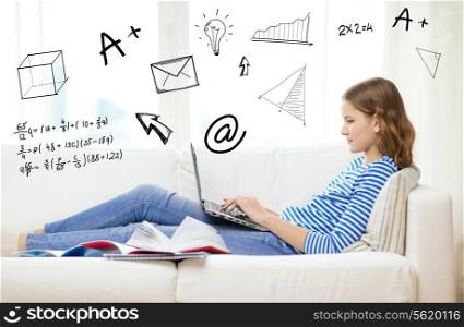 home, education, technology and internet concept - busy teenage girl lying on the couch with laptop computer, book and notebooks at home