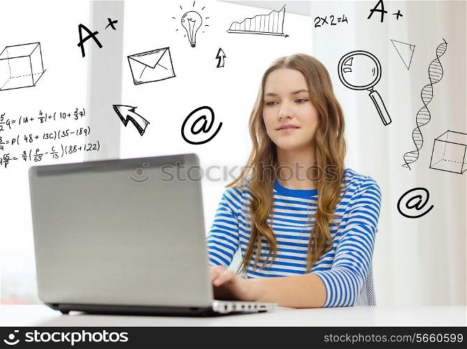 home, education, technology and internet concept - smiling teenage girl with laptop computer sitting at table at home