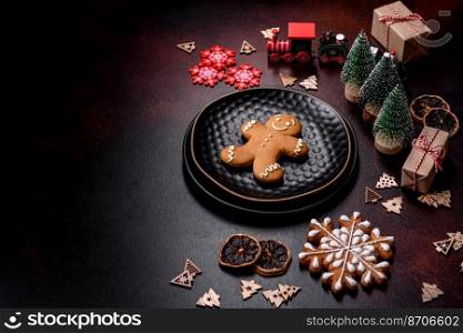 Home festive Christmas table decorated by toys and gingerbreads on a dark concrete background. Home festive Christmas table decorated by toys and gingerbreads