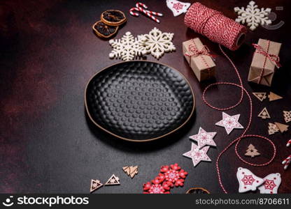 Home festive Christmas table decorated by toys and gingerbreads on a dark concrete background. Home festive Christmas table decorated by toys and gingerbreads