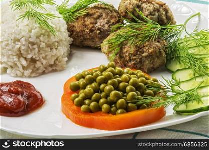 Home food. Cutlet from minced meat with boiled rice and fresh vegetables