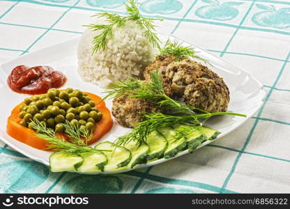 Home food. Cutlets with boiled rice and vegetables