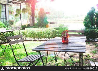 Home garden with wooden table and chairs