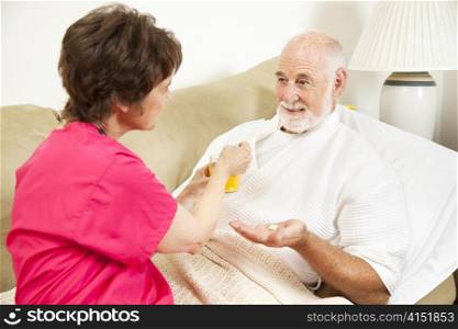 Home health nurse giving an elderly patient juice to make his medicine go down.
