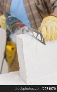 Home improvement - handyman cut brick with saw, close-up