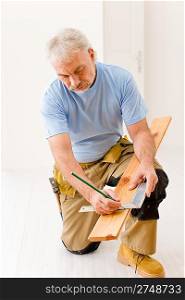 Home improvement - handyman installing wooden floor home