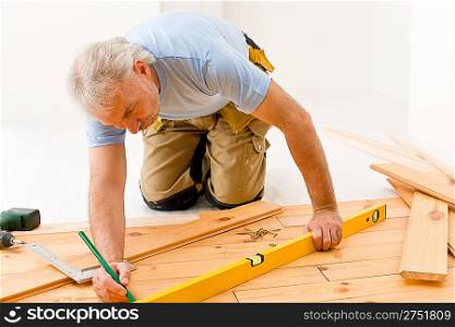 Home improvement - handyman installing wooden floor home