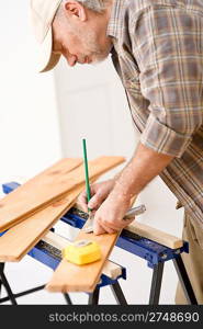 Home improvement - handyman prepare wooden floor in workshop