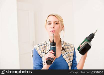 Home improvement - woman with battery cordless screwdriver