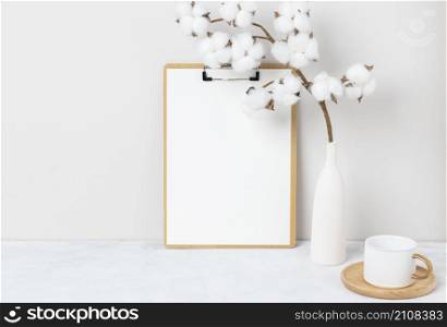Home interior floral decor, Cotton flower on table, Front view, Blank paper cards, Greeting card Mockup. Beautiful white cotton flowers in vase on white background