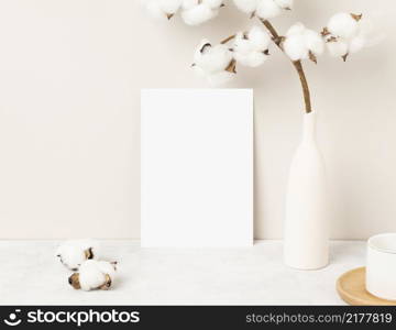 Home interior floral decor, Cotton flower on table, Front view, Blank paper cards, Greeting card Mockup. Beautiful white cotton flowers in vase on white background