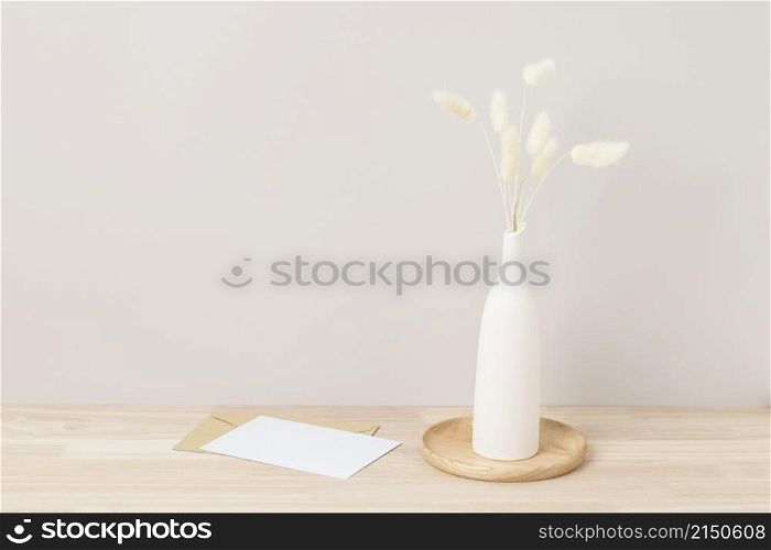 Home interior floral decor, pampas grass on table, Front view, blank paper card, Greeting card Mockup. Beautiful white pampas grass in vase on white background