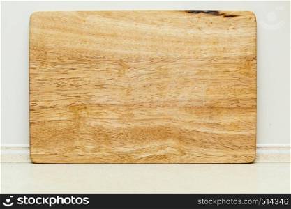Home interior objects concept. Detailed top view closeup of old fashioned wooden kitchen board. Detailed closeup of wooden kitchen board