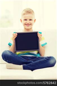 home, leisure, advertising and technology concept - smiling little boy with blank black tablet pc computer screen at home