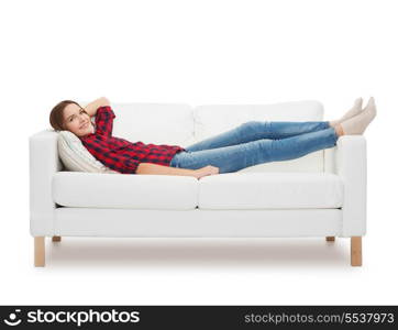 home, leisure and happiness concept - smiling teenage girl lying on sofa