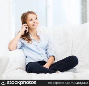 home, leisure, technology and internet concept - little student girl with smartphone at home