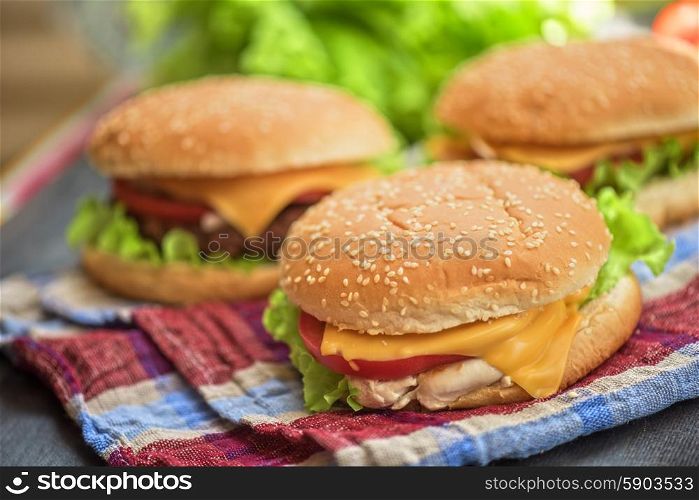 home made burgers. Closeup of home made burgers on wooden table