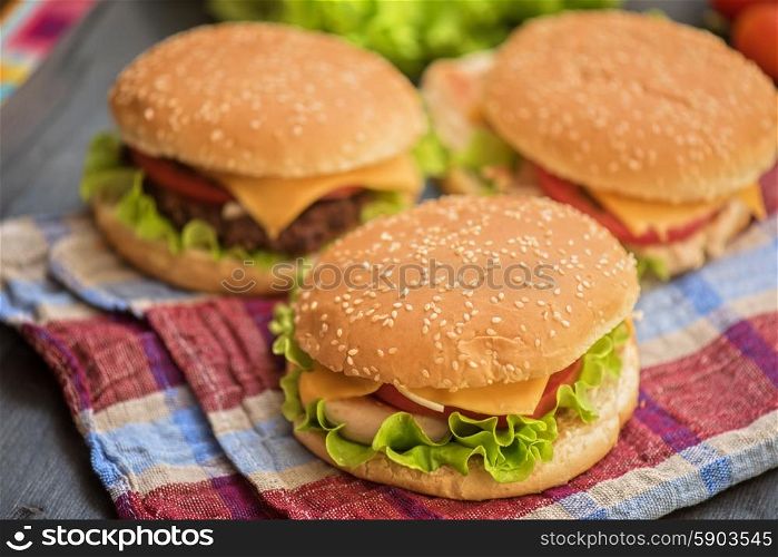 home made burgers. Closeup of home made burgers on wooden table