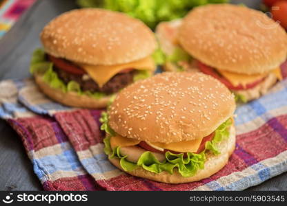 home made burgers. Closeup of home made burgers on wooden table