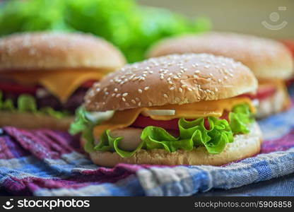 home made burgers. Closeup of home made burgers on wooden table