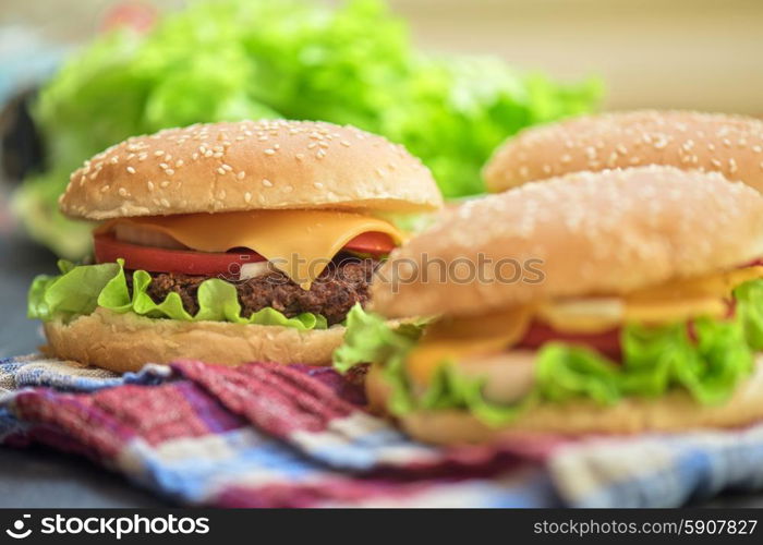 home made burgers. Closeup of home made burgers on wooden table