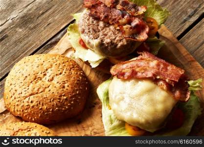 Home made cheeseburgers on rustic wooden table