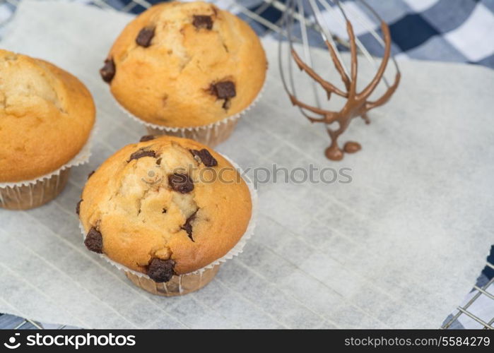 Home made chocolate chip muffins with melting chocolate on whisk