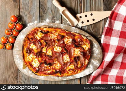 Home made pizza on wooden rustic table