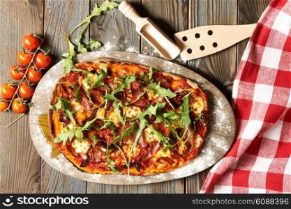Home made pizza on wooden rustic table